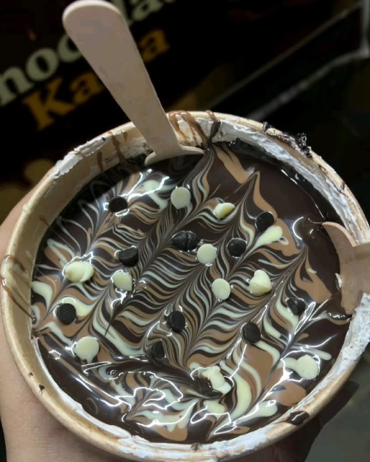 Chocolate lava cup dessert with marbled dark, milk, and white chocolate swirls and chocolate chips.