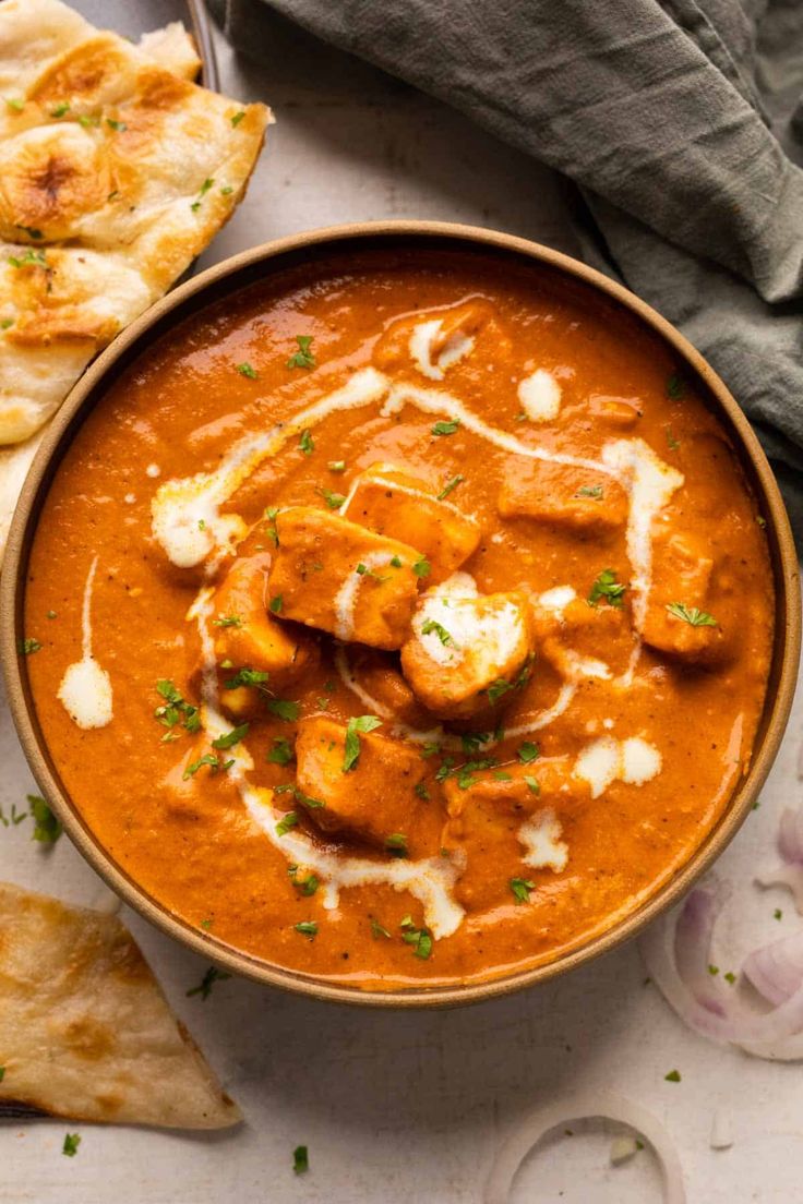 Creamy Paneer Butter Masala curry garnished with fresh cream and coriander in a serving bowl.
